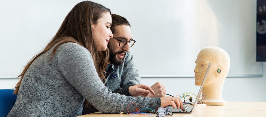 Image of PhD students Lorena Qendro (left) and Andrea Ferlini working with a Nokia Bell Labs' earable prototype as part of a collaboration with Nokia Bell Labs.