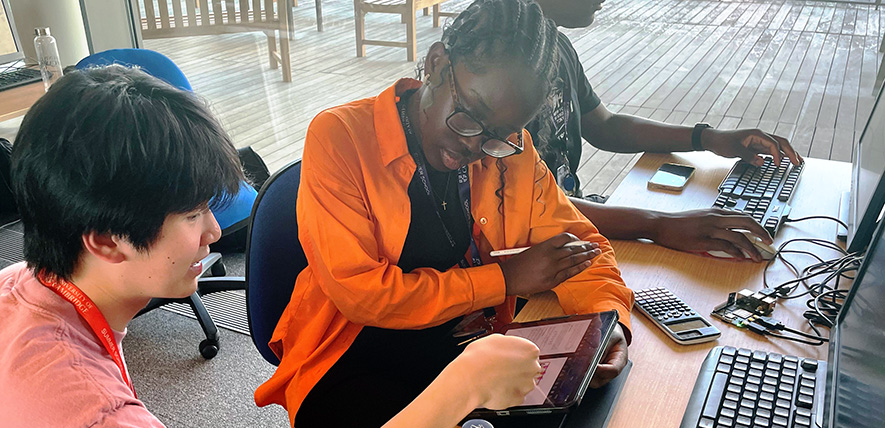 A participant working with a subject ambassador at the 2023 Sutton Trust Summer School