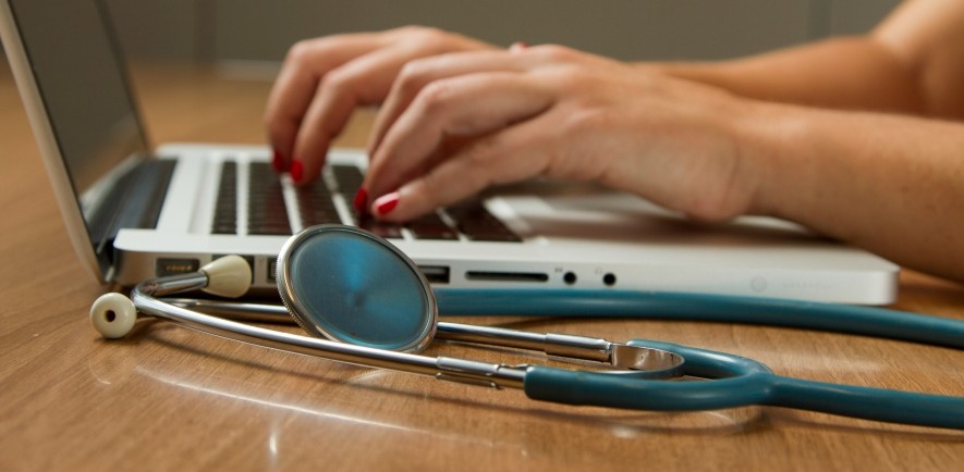 Image of clinician using laptop and stethoscope from Unsplash.com