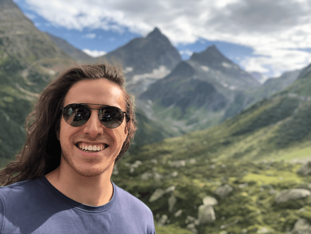 Headshot - Indigo with mountains in the background.